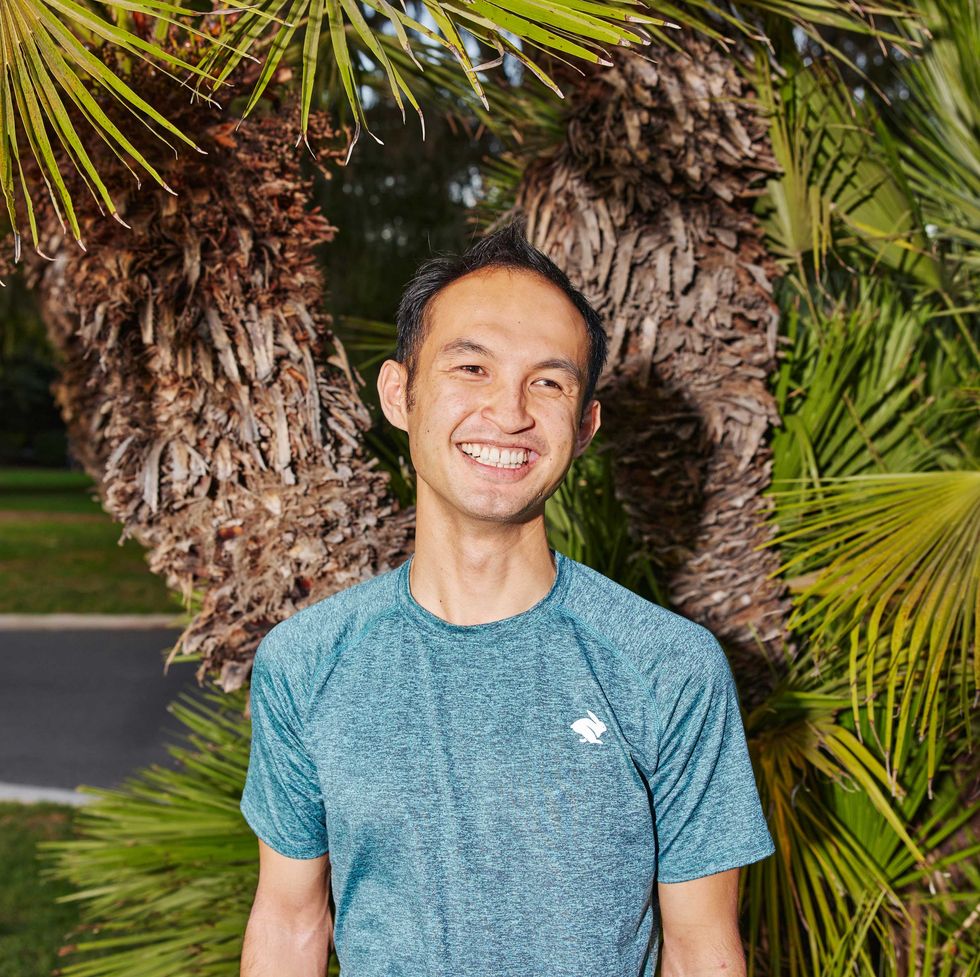 Headshot of Newton wearing running gear and standing in front of a tree in California